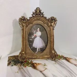 Detailed view of an ornate vintage gold resin picture frame with classical portrait
