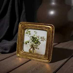 Macro view of a vintage European style gold carved frame with white flower oil painting