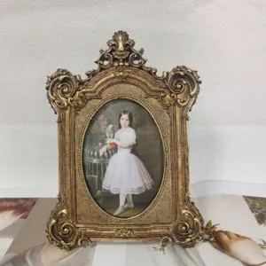 Detailed view of ornate vintage gold resin photo frame with classical painting