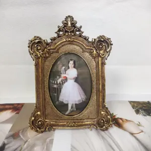 Detailed view of ornate gold vintage resin photo frame with classical portrait painting