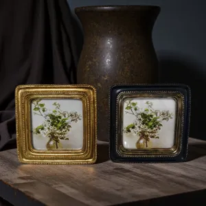 Detailed close-up view of vintage European embossed frames in gold and black finishes