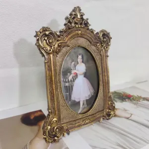 Close-up of a vintage ornate gold resin photo frame with classical portrait art