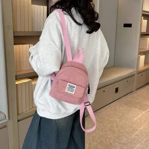 Fashionable pink corduroy mini backpack for women in a casual lifestyle setting