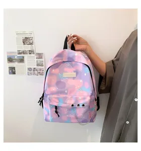 Close-up of a pastel cloud-patterned school backpack with stars and decorative metal chain