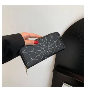 Close-up of black long zipper wallet featuring a white spiderweb and heart print.