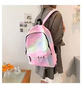 Side view of a pastel gradient canvas student backpack with silver chain detail worn by a model