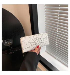 Detailed view of fashionable white long wallet with spider web and heart pattern