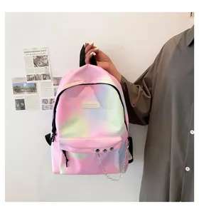 Close-up of a stylish rainbow gradient backpack featuring a decorative silver chain detail.