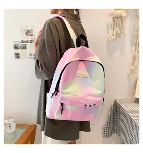 Detail showing the pastel gradient canvas backpack with stylish silver chain accent