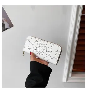 High-quality detail of women's white long zip wallet with heart and spider web print