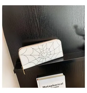 Stylish white long zipper wallet for women featuring a black spiderweb heart print detail