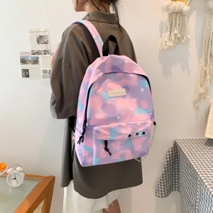 Back view of girl wearing a pink and purple galaxy patterned backpack with chain detail