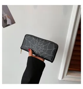 Detailed view of black zip-around long wallet featuring a white spiderweb print pattern