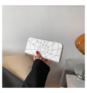 White zip-around wallet with spider web pattern and heart center detail