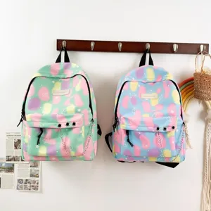 Two pastel canvas backpacks with star and heart patterns and chain details on a rack