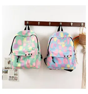 Detailed view of two preppy style canvas school backpacks with colorful patterns and chains