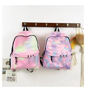Detailed view of colorful gradient and patterned canvas school backpacks hanging.