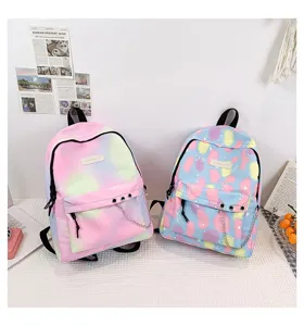 Lifestyle detail showing two colorful pastel canvas backpacks for students with chain decor