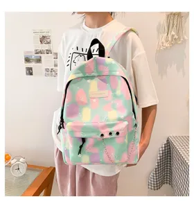 Detailed view of a pastel marble canvas backpack with metal chain and ring accessories