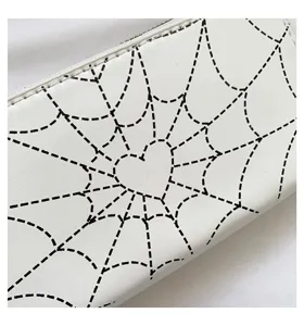 Close-up of gothic spiderweb heart print on a white long zipper wallet for women