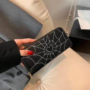 Black long zip-around wallet for women featuring white spiderweb and heart print