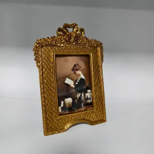 French vintage gold resin photo frame with bow and floral carvings for home desktop decor.