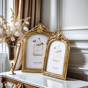 Vintage gold photo frame set with ornate baroque relief design, perfect for tabletop decor.