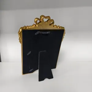 Detailed rear view of a French vintage gold photo frame, showing the easel stand and sturdy back.