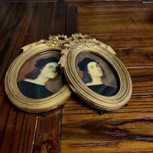 Detail view of ornate golden resin photo frames in vintage European palace style design