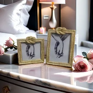 Gold picture frame with knot detail, luxury tabletop photo holder for bedroom decor.
