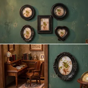 Set of vintage black and gold ornate picture frames with floral art on a green textured wall
