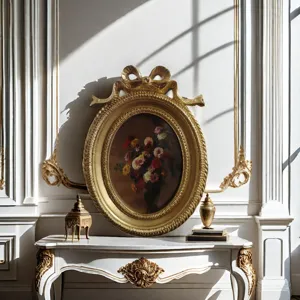 Detail shot of a vintage golden oval picture frame with elegant bow decoration on top