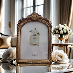 Vintage gold ornate photo frame with exquisite carved arch design for elegant home decor.