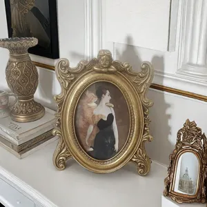 Vintage ornate gold resin photo frame with cherub detail in home setting