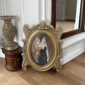 Elegant ornate gold resin photo frame with vintage cherub carving and classic portrait