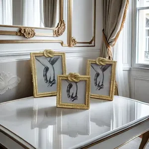 Exquisite gold woven photo frames set on table, elegant home decor detail shot displaying art.