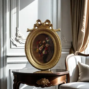 Vintage ornate oval gold picture frame with bow detail and floral oil painting detail