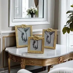 Luxurious gold picture frames set of three with decorative rope knots for living room decor