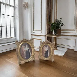 Pair of vintage golden carved resin photo frames in a classical interior setting