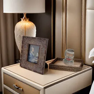Vintage ornate photo frame displayed on an elegant bedside table for home decor