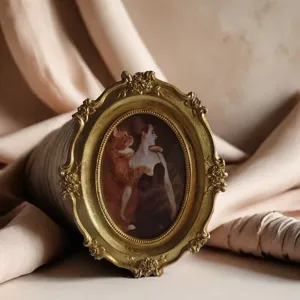 Elegant vintage golden oval photo frame featuring floral rose relief and a classical portrait
