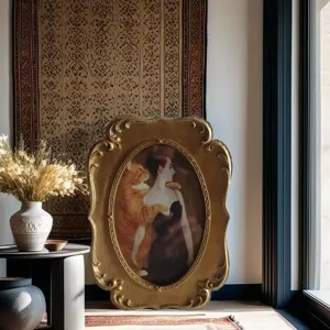 Detailed view of a vintage ornate golden oval photo frame in an elegant interior setting