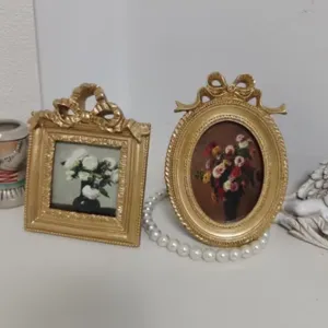 Vintage ornate gold picture frames with floral art and bow relief for tabletop decor