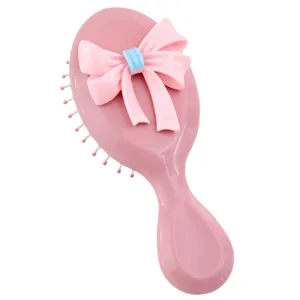 Brosse à cheveux rose portable à coussin d'air avec un nœud décoratif pour les filles