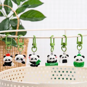 Cute panda keychain pendant detail showcasing various cute poses and green metal hooks.