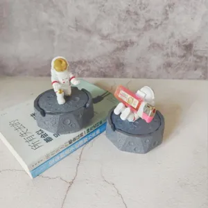 Detail shot of creative astronaut moon resin ashtray, unique desktop decor and gift piece.