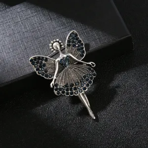Close-up of vintage silver ballerina brooch with dark blue rhinestones and wings.