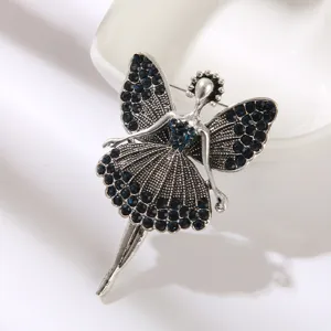 Close-up of vintage dancing girl brooch with elegant blue rhinestone detailing