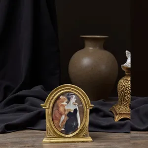 Exquisite detail view of a vintage European style carved resin photo frame on wood