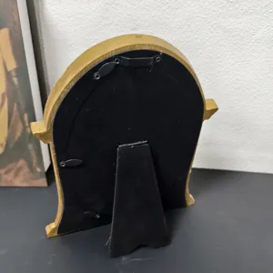 Detailed view of the back of a retro resin photo frame with stand and hanging hook